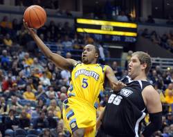 Marquette's Junior Cadougan (5), a sophomore, goes up for a shot while being
guarded by Providence's Ray Hall (55), a senior, Sunday, Feb. 27, 2011, during a...
