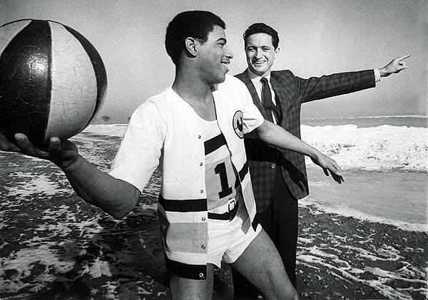 Pat Smith prepares to toss the basketball into Lake Michigan as Al Mcguire... Pat Smith prepares to toss the basketball into Lake Michigan as Al Mcguire...